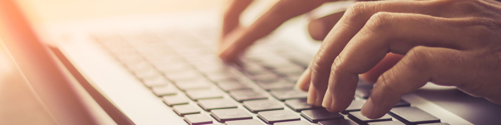 Hands on a Laptop Keyboard